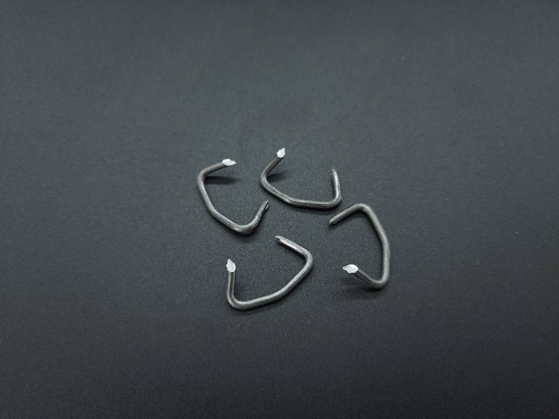 Four sharp-point pre-bent upholstery hog rings