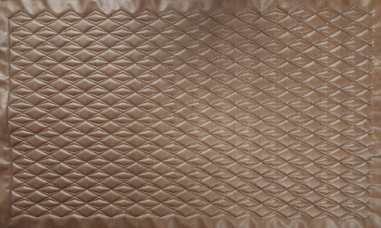 Diamond in Diamond 48 × 28-inch CNC-stitched upholstery panel shown flat in amber vinyl with brown thread