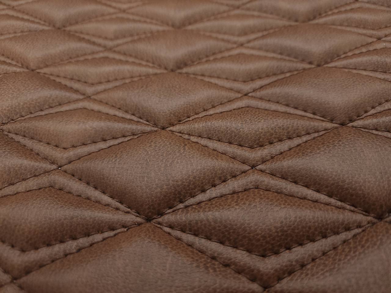 Booth-lit close-up of 3/8-inch foam quilting on a Pinnacle 804 Amber CNC panel