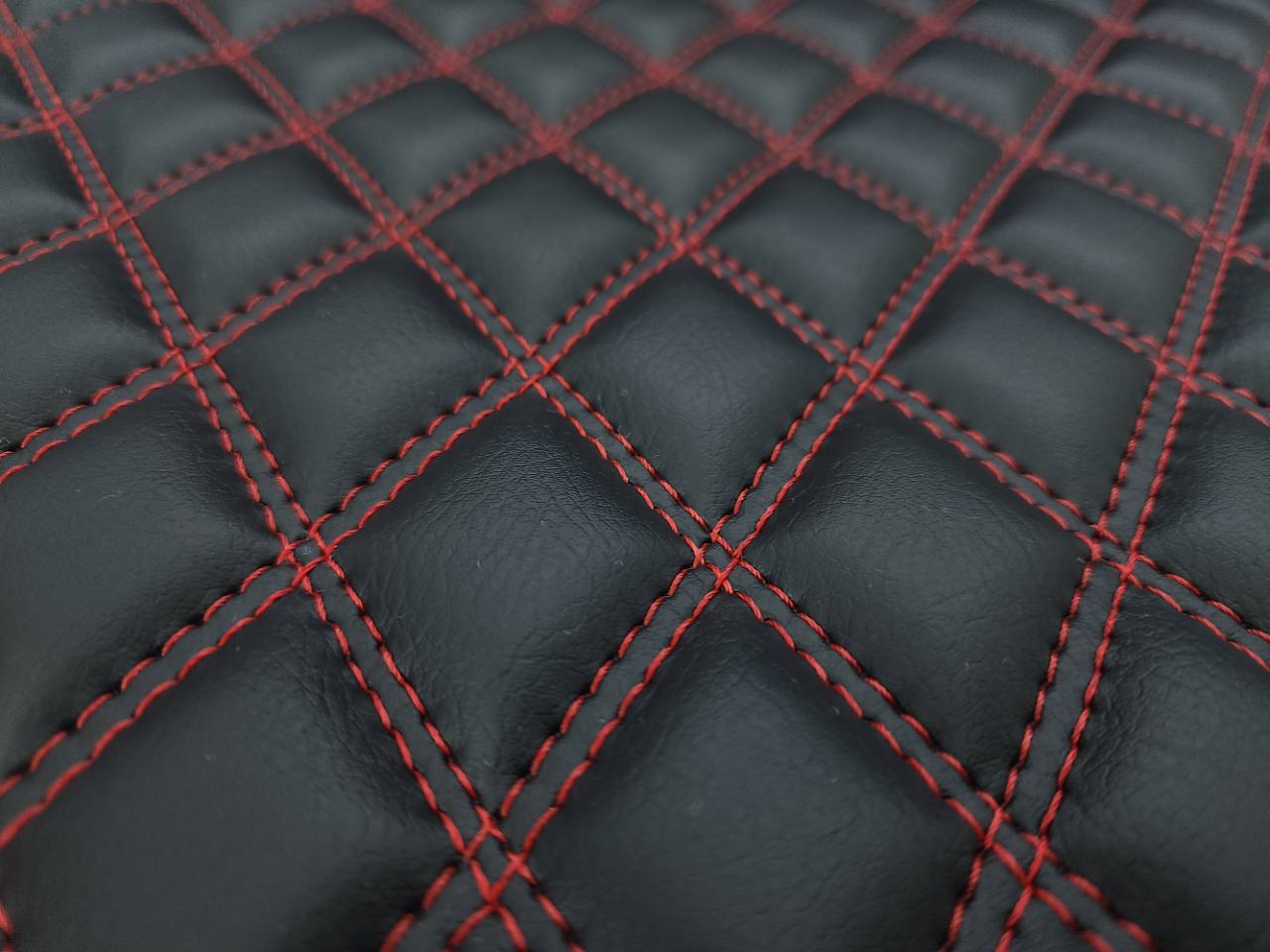 Close-up of 3/8-inch foam quilting on a black Pinnacle 909 Raven Double Diamond Vertical panel