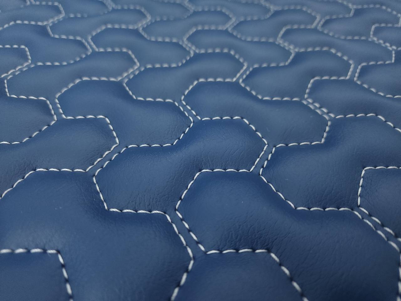 Close-up of 3/8-inch foam quilting on a Pinnacle 306 Naval Blue Hex Cells panel