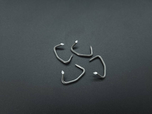 Four sharp-point pre-bent upholstery hog rings