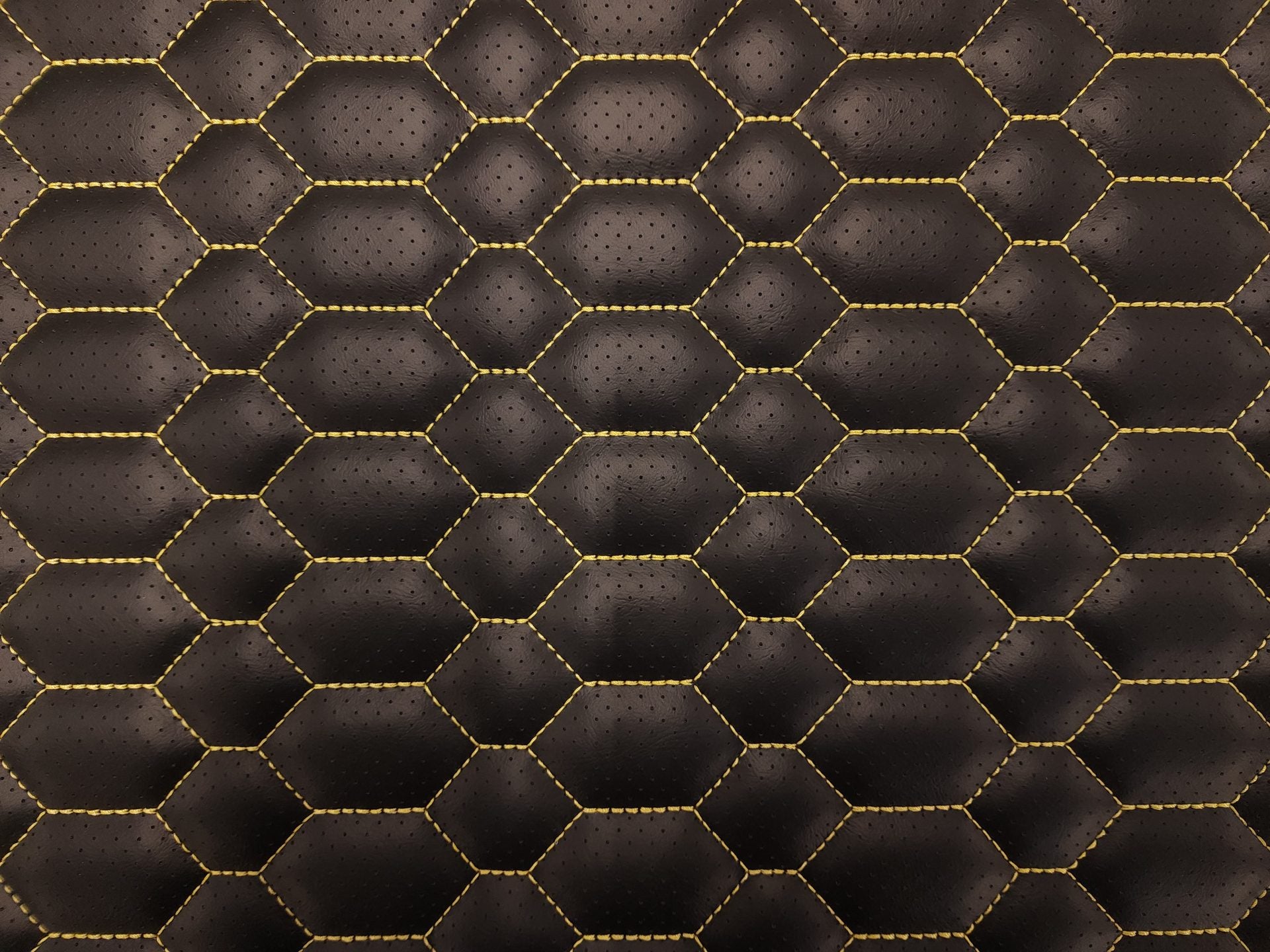 CNC beehive stitch pattern on black vinyl with gold thread